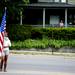 A Memorial Day Parade member waits with an American Flag on West Cross Street on Monday, May 27. Daniel Brenner I AnnArbor.com